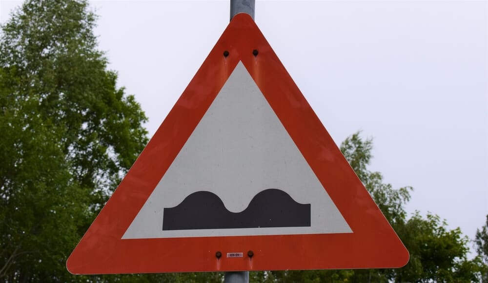 uneven road sign